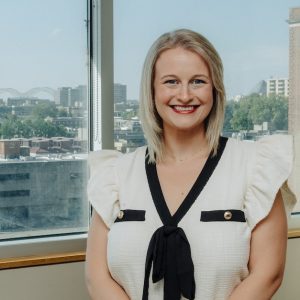 Photo of Avery Dargie with a view of Memphis through the window behind her.