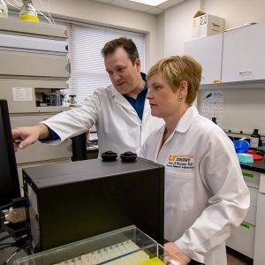 Dr. Trey Fisher and Dr. Deidra Mountain working in the lab
