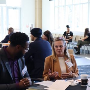 Attendees at the Mental Health Summit in Chattaooga talk with each other.