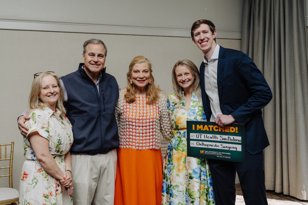 Two medical students, Avery Dargie and her fiancé, pose with Dr. Catherine Womac and Dargie's parents.