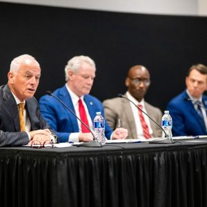 Peter Buckley, Glenn Boyce, Charles Robinson, and Bill Hardgrave sit side-by-side at a table while announcing the Mid-South AI Research Consortium