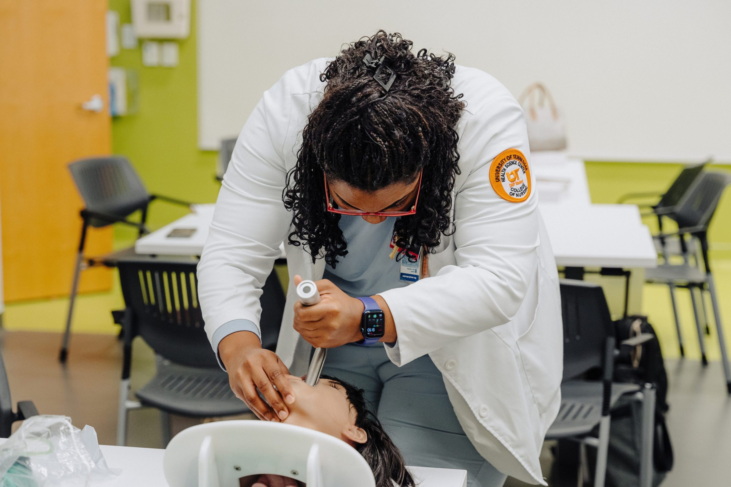 A DNP student practices intubating a manikin head.