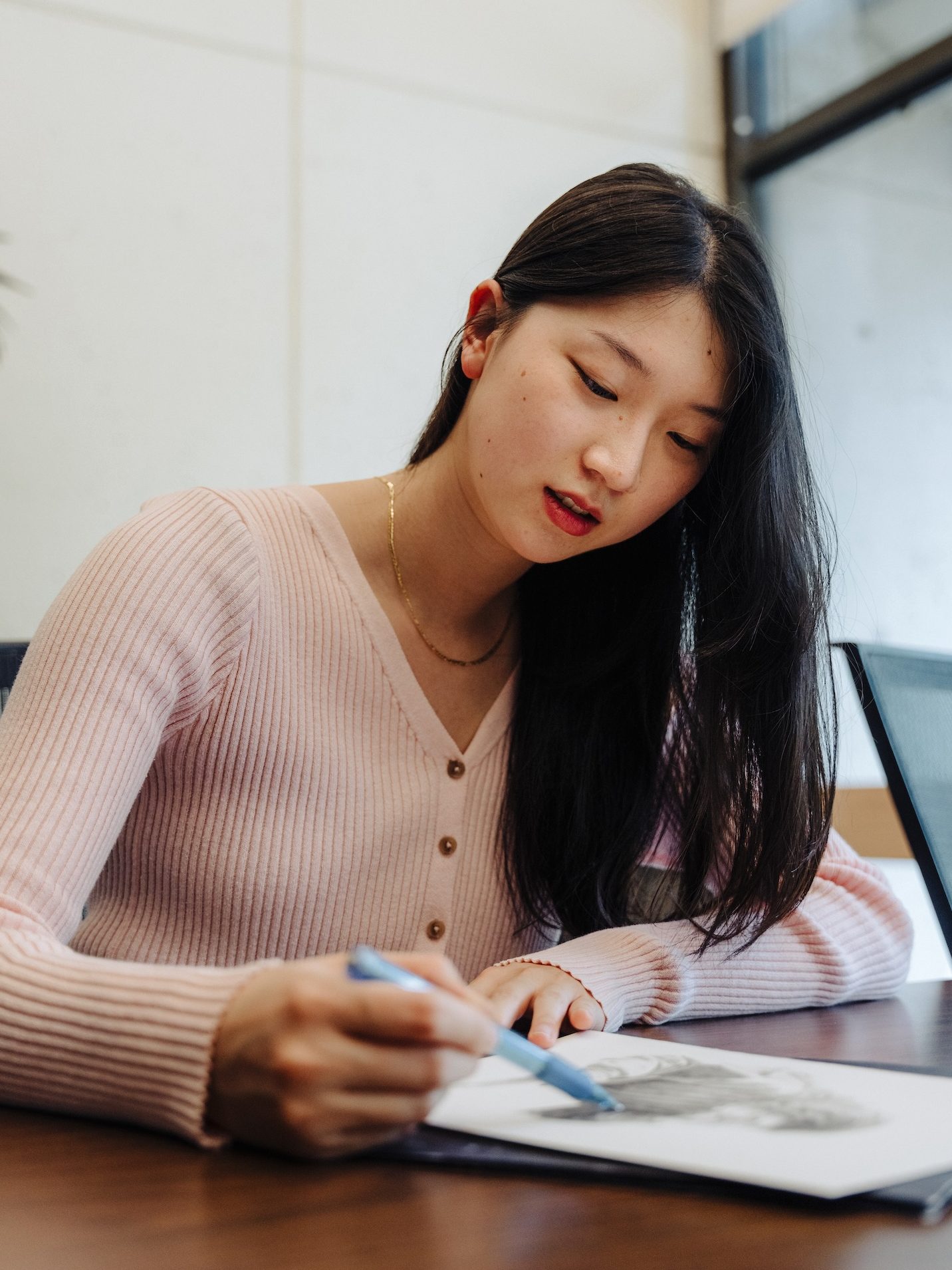Emily Lu working on her art.
