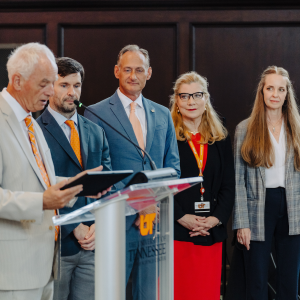 Chancellor Peter Buckley, MD, reads from a plaque at the podium to Memphis Medical Society's Clint Cummins and Drs. Dale Criner, Catherine Womack and Michelle Allmon.