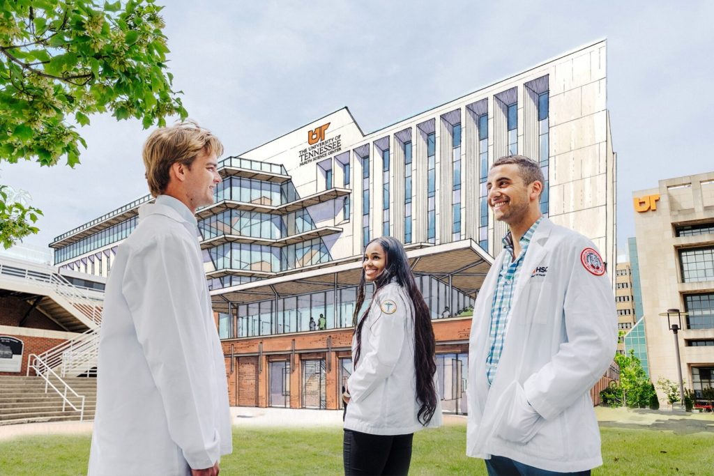 College of Medicine students stand in front of the future site of the College of Medicine Interdisciplinary Building, with a rendering of the building in the background.