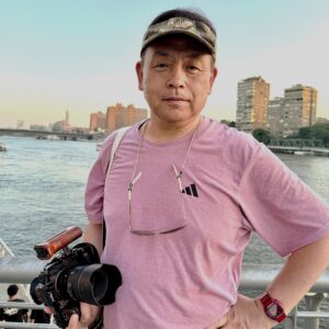 Dr. Michio Kurosu holds his camera by the Nile River.